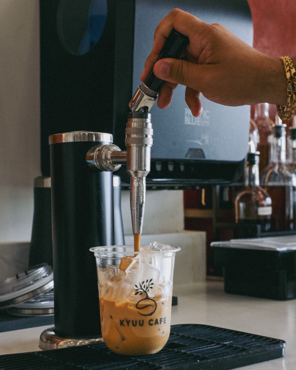 Nitro brown butter brown sugar latte pouring from the tap at Kyuu Cafe